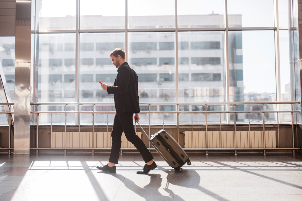 man walking with suitcase